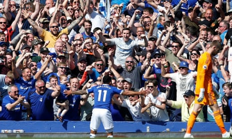 Everton’s Theo Walcott celebrates scoring their fourth goal with fans.