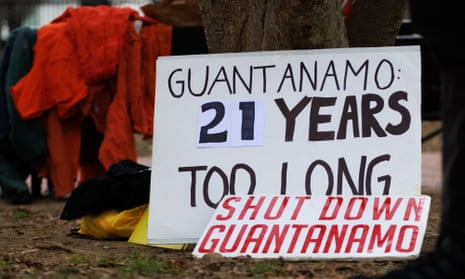 Signs rest on a tree during a protest near the White House in Washington DC on 11 January 2023, the 21st anniversary of the opening of the detention facility at Guantánamo Bay.