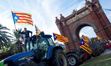 Farmers wave estelada flags on top of tractors before Puigdemont’s speech in Barcelona.