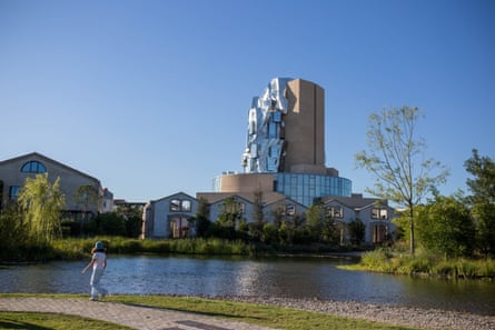Buildings and a tower comprising bricks with a modernist metal structure on one side