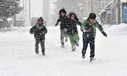 Children play in the snow in the city of Kars.
