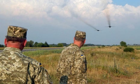 Ukrainian soldiers watch frontline bombers during military drills in the Rivne region