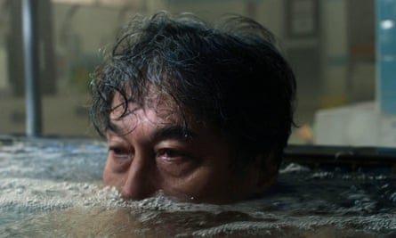 Close-up of a man in some type of bath, submerged up to his nose
