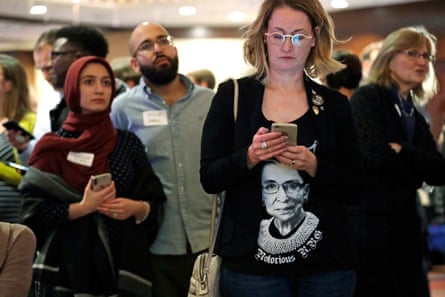 A woman wears a shirt with a likeness of Ginsburg as she checks returns at an election night party for Democrats on 6 November.