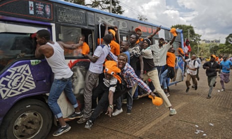 Supporters of opposition leader Raila Odinga ride on the outside of a ‘matatu’ minibus as they arrive for a rally in Uhuru Park in downtown Nairobi, which was later cancelled.