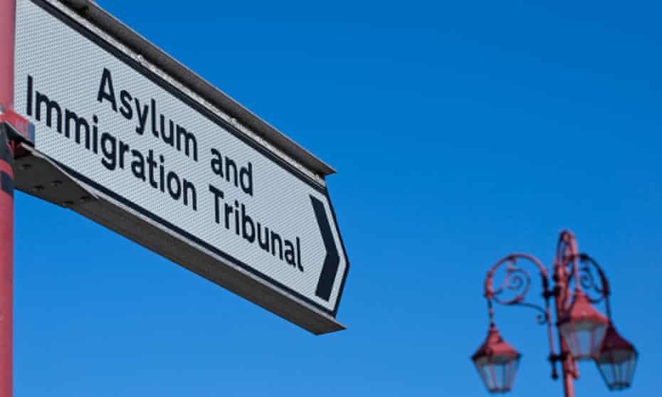A sign pointing towards an asylum and immigration tribunal building in Surbiton, Surrey