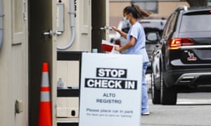 A medical worker collects a sample at a coronavirus testing centre in Newark, New Jersey