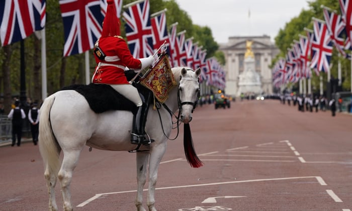 A military horse on The Mall ahead of the ceremonial procession of the coffin of Queen Elizabeth II from Buckingham Palace to Westminster Hall.