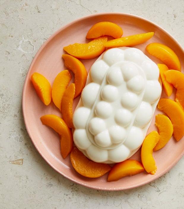 Olia Hercules’ baked milk yoghurt jelly, with tinned peach segments.