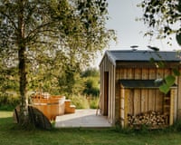 A wooden cabin with a hot tub