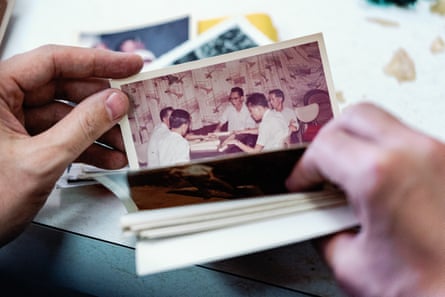 Hands sift through a stack of photos