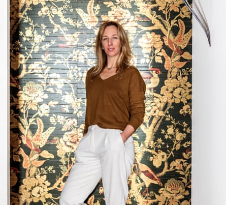 Samantha Hauvette standing in front of a wall with elaborately patterned wallpaper