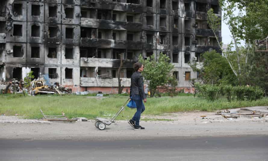 Russia-Ukraine war: Severodonetsk one of Russia’s ‘immediate tactical priorities’, UK says – live 3 A woman walks past a destroyed building amid Russian attacks in Mariupol, Ukraine