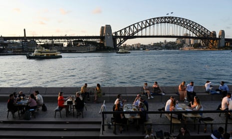 Patrons dine-in at a bar by the harbour as Covid-19 regulations ease in Sydney. 