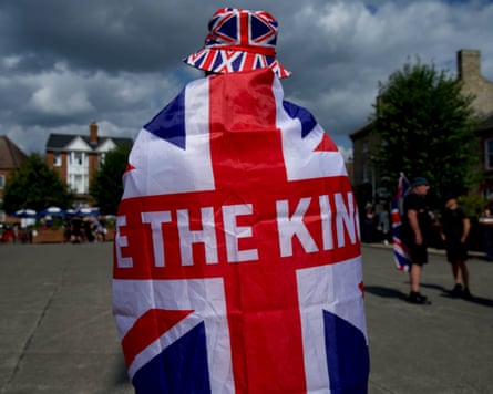 A man clad in a union flag emblazoned with ‘Unite the Kingdom’ outside Thetford town hall