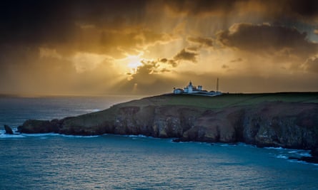 Lizard Lighthouse, with cottages, at sunset.