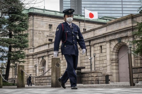 A security officer patrolling around the Bank of Japan (BoJ) headquarters in Tokyo.