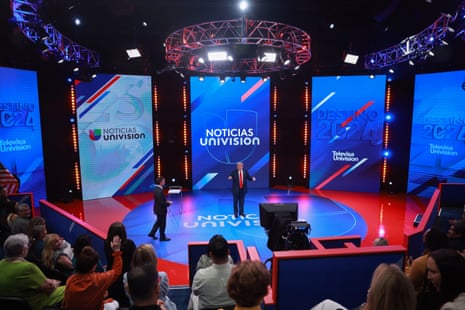 Republican presidential nominee, former US president Donald Trump stands with moderator Enrique Acevedo (L) as he attends a Univision Noticias town hall event in Florida on Wednesday.
