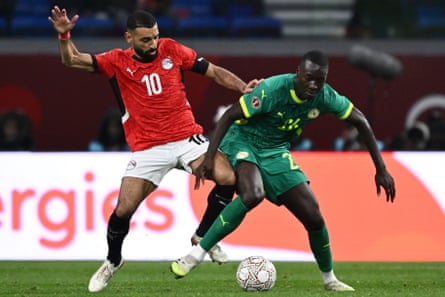 Mohamed Salah battles for the ball with Pape Gueye.