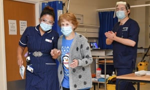 Keenan holding hands with May Parsons after receiving the vaccine.
