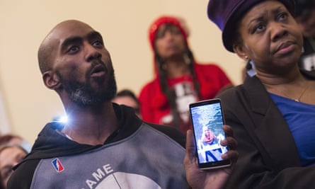 Flint resident Demeceo Braylock shows a photo of his nephew during a news conference on Capitol Hill in Washington.
