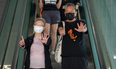 Former lawmakers Lee Cheuk-yan, (right), and Cyd Ho, (left), leave the West Kowloon court buildings in Hong Kong on Thursday.