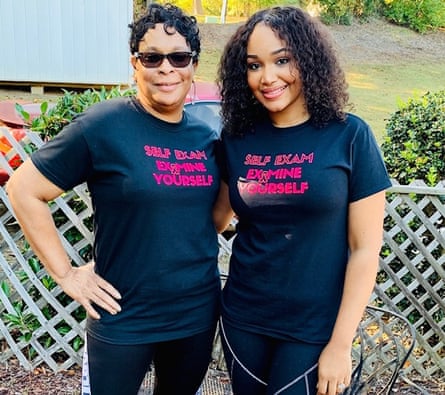 Two women smiling wearing a shirts that say “self exam - examine yourself”