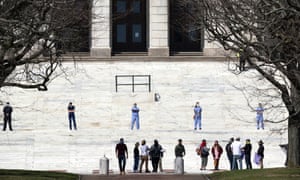 Nurses stand in counter-protest on the State House steps as people linger after a demonstration against stay-at-home orders due to coronavirus, 25 April 25 2020, in Providence, Rhode Island, in the US.