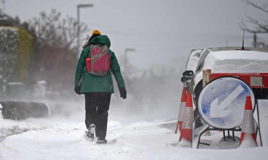 A woman walks through the snow in the village of Marsden, east of Manchester.