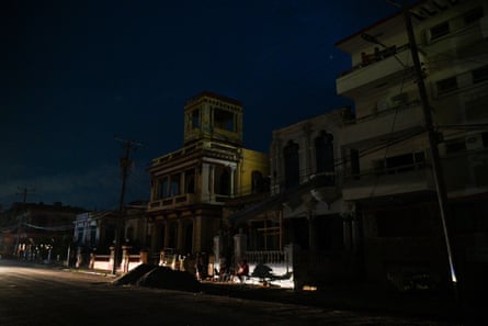 People gather on a street during a blackout in El Vedado neighbourhood in Havana.