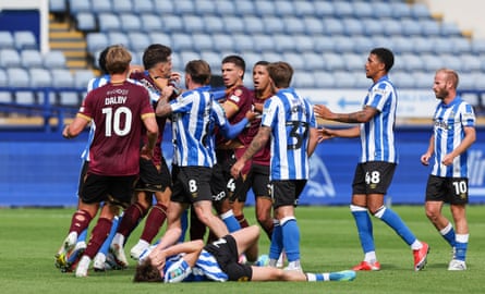 Players confront each other before Bolton’s Xavier Simons is shown a red card in their defeat to Sheffield Wednesday.