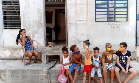 Children talk while wearing masks to protect themselves from the coronavirus pandemic in Havana, Cuba, on 7 August 2020.