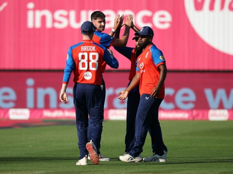 Josh Tongue celebrates with teammates after taking the wicket of Tilak Varma.