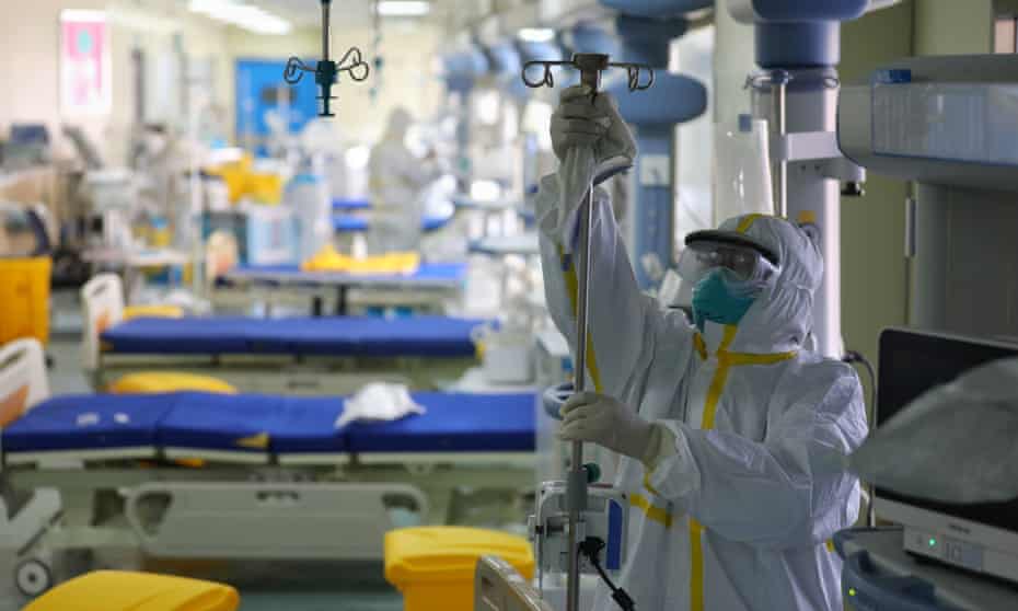 A medical worker disinfects a ward in Wuhan union hospital, China. Cases emerged in November, Chinese government data reportedly sugests.