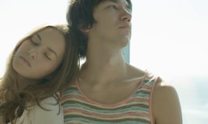 Man and woman sitting in front of window