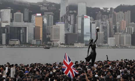 Thousands of protesters carrying the British flag march in Hong Kong in July 2019.