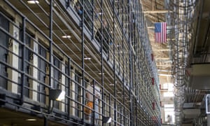 An inmate walks to his cell as corrections officers patrol at San Quentin State Prison in San Quentin, California, in August 2016