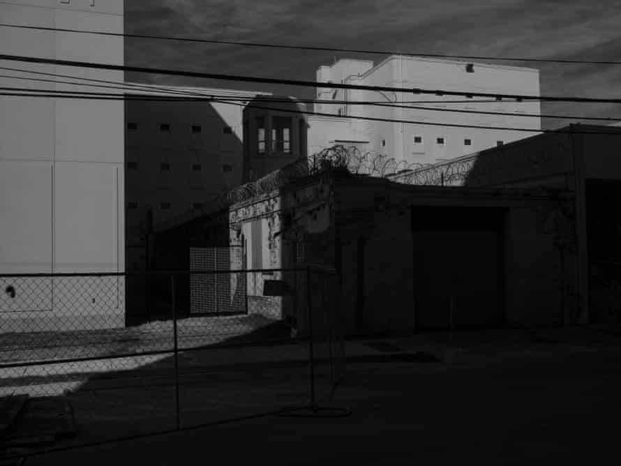A guard tower, surrounded by barbed wire, near the Orleans parish criminal courthouse.