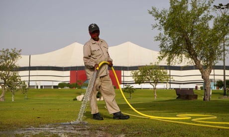 A worker tends the grounds at Al Bayt stadium in Qatar