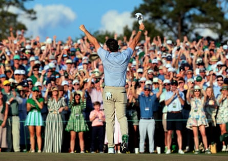 Rory McIlroy celebrates on the 18th green after retaining his Masters crown at Augusta