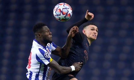 Zaidu Sanusi of Porto competes for the ball with Manchester City’s Phil Foden.