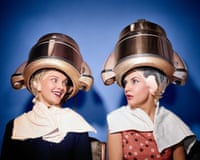 Two 1950s Women Sitting Under Beauty Salon Hair Dryers Wearing Hairnets Towels Talking Gossip