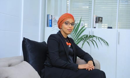 Filsan Abdi sits on a sofa in an office.