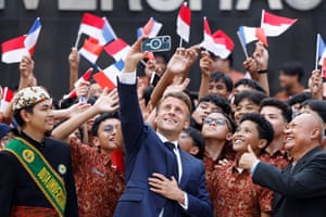 President Emmanuel Macron takes a selfie with students