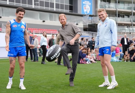 Prince Harry kicks a Sherrin ball during a Western Bulldogs Australian rules football session in Melbourne