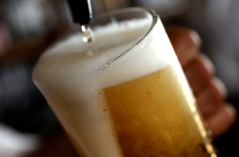 A pint of beer is poured into a glass