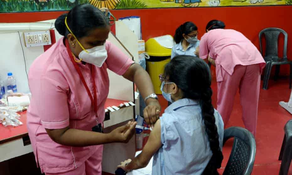 Students of a private school receive a Covid vaccine in Kolkata, India.