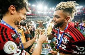 Rodrigo Caio and Gabriel Barbosa celebrate with the league title in Brazil.