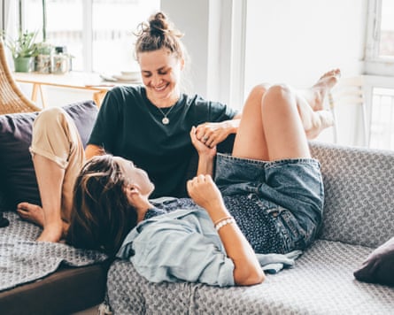 Female couple enjoying time together on a sofa.