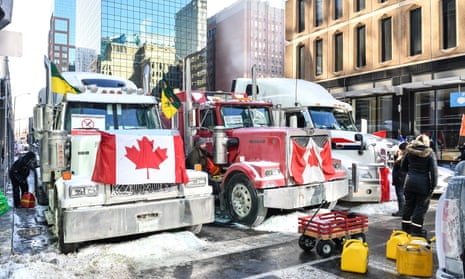Truckers refuel their trucks in the cold during the Freedom Convoy truck protest in Ottawa, Canada. Truckers continue their rally over the weekend near Parliament Hill in hopes of pressuring the government to roll back Covid-19 public health regulations and mandates.